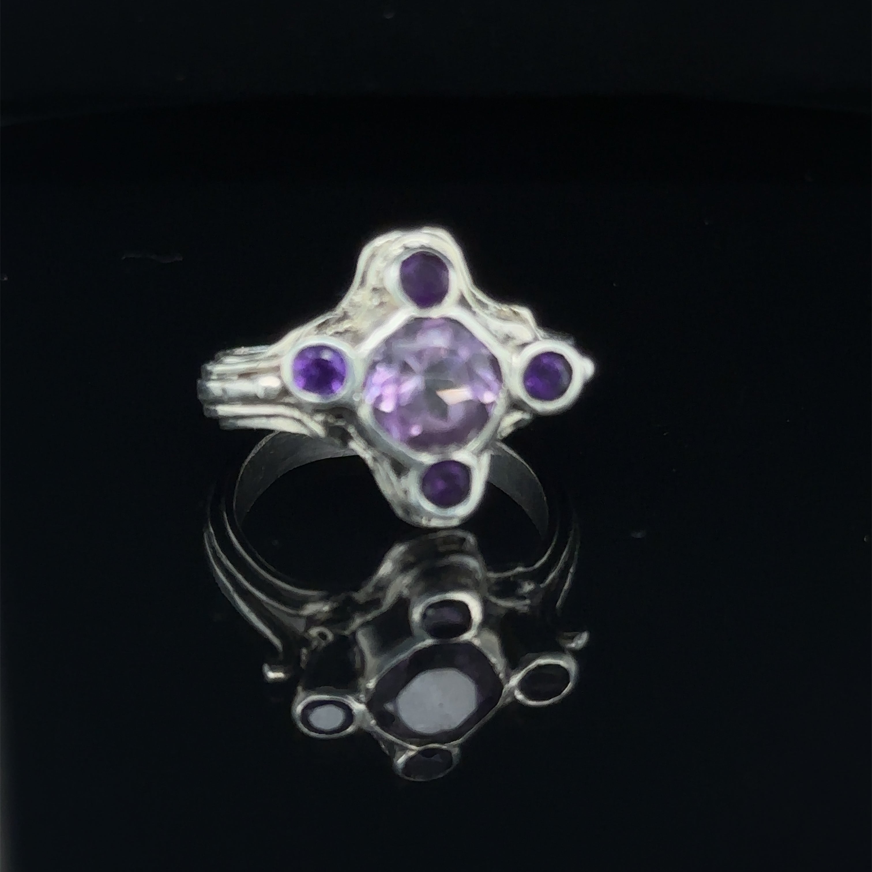 Luxury gemstone ring perfect for gifting or personal wear, size seven on black  right-angle view
