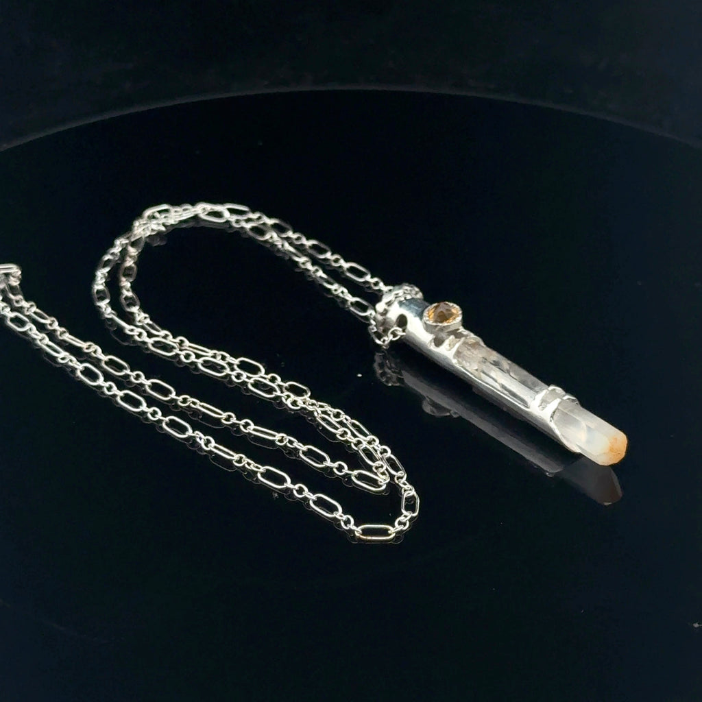 Mango Quartz Lightsaber Necklace in a Sterling Silver case with citrine gemstones to accent the pendant on a black background, front left angle view. 