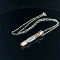 Mango Quartz Lightsaber Necklace in a Sterling Silver case with citrine gemstones to accent the pendant on a black background, front right angle view. 