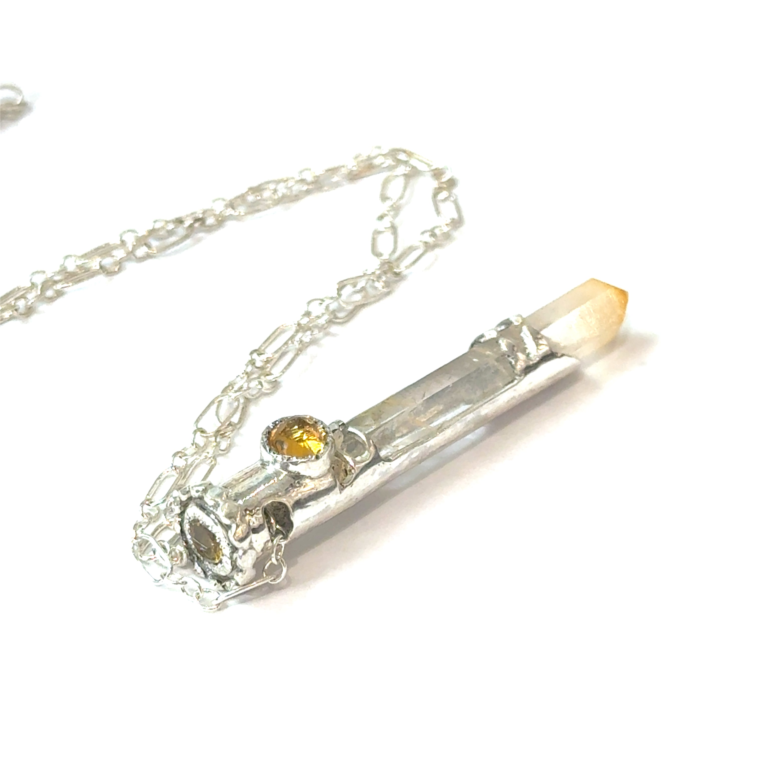 Mango Quartz Lightsaber Necklace in a Sterling Silver case with citrine gemstones to accent the pendant on a white background, in a models finger tips, back view. 