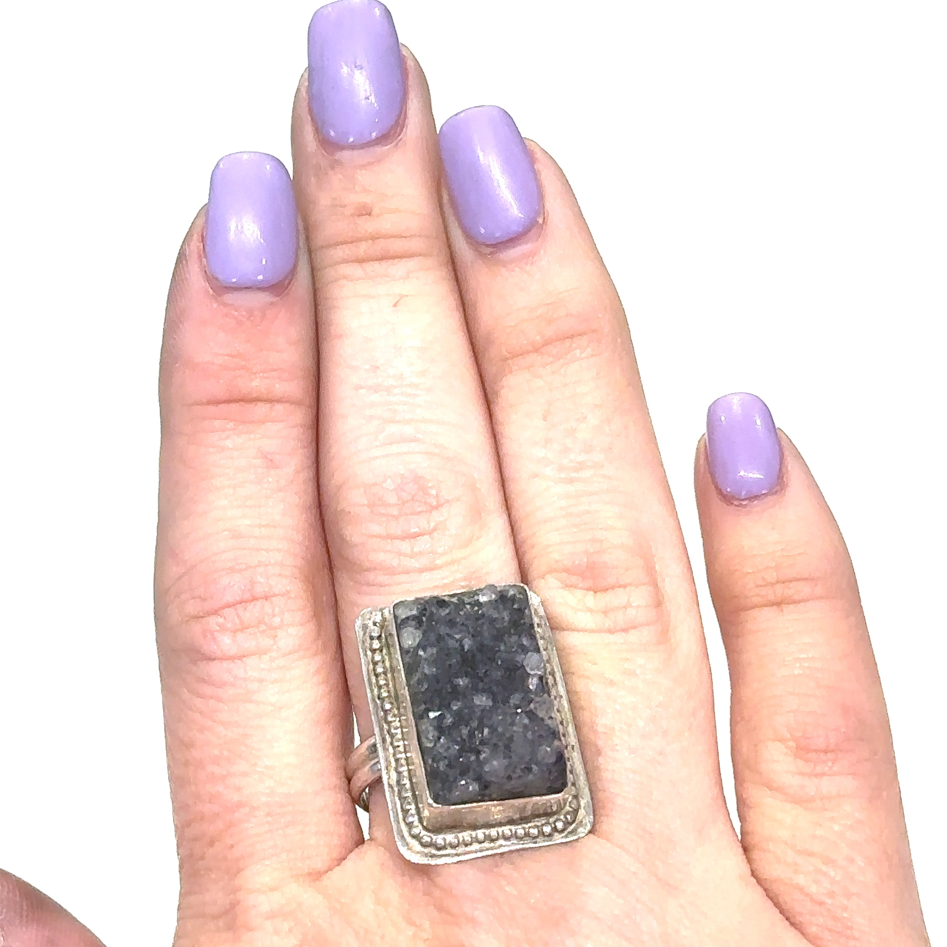 Model wearing Amethyst druzy gemstone ring with sterling silver band, reflecting spiritual elegance on white front view