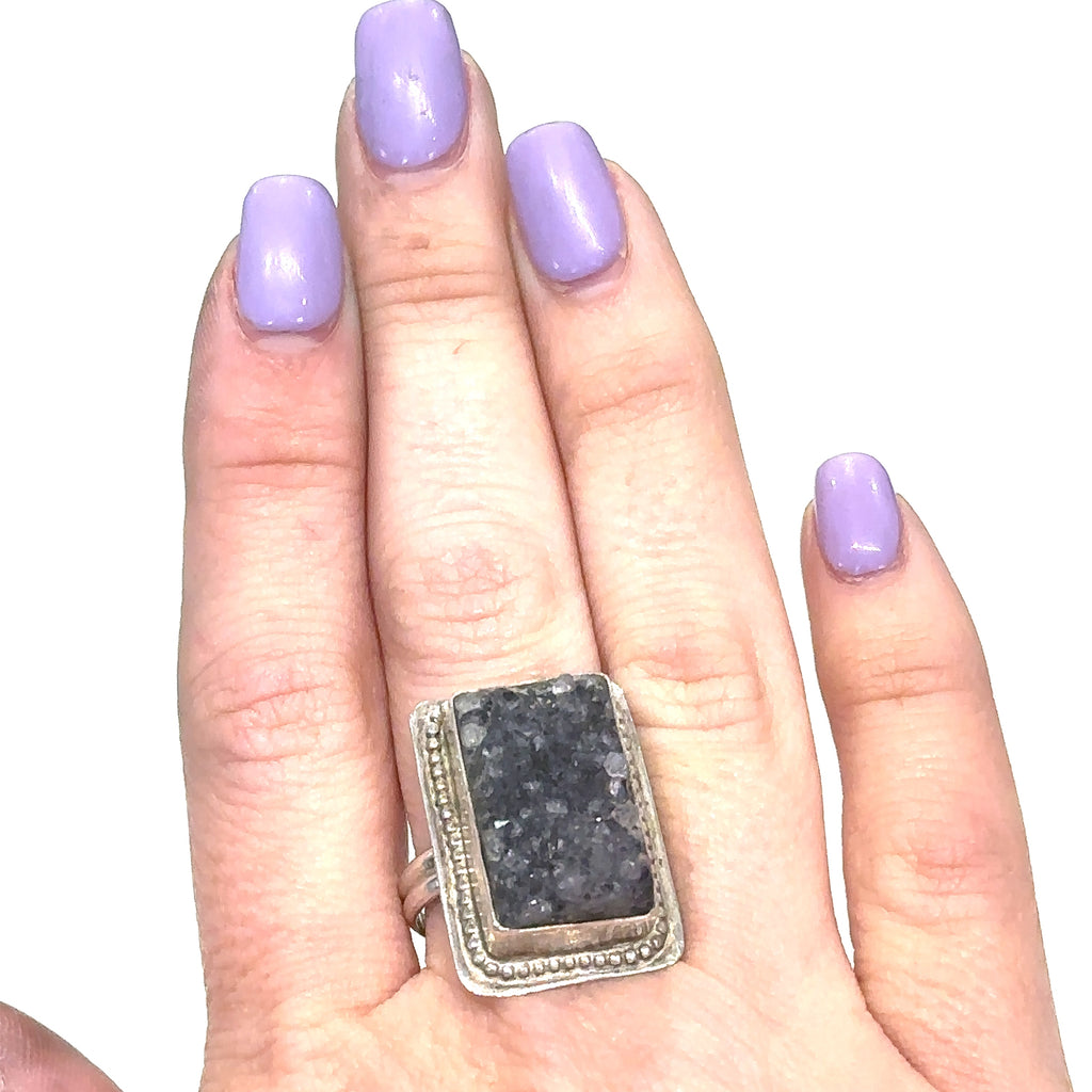 Model wearing Amethyst druzy gemstone ring with sterling silver band, reflecting spiritual elegance on white front view