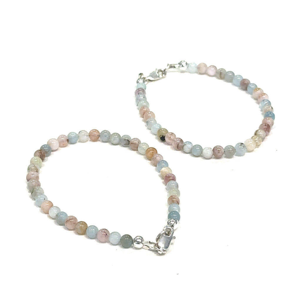 Morganite crystal bracelet for divine love and spiritual healing grouping on white top overview 