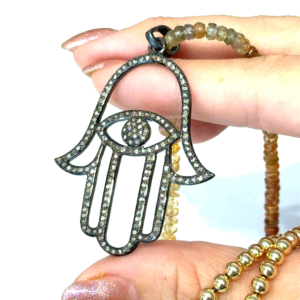 Multicolored Sapphire Gemstone Necklace on white up close  in hand view