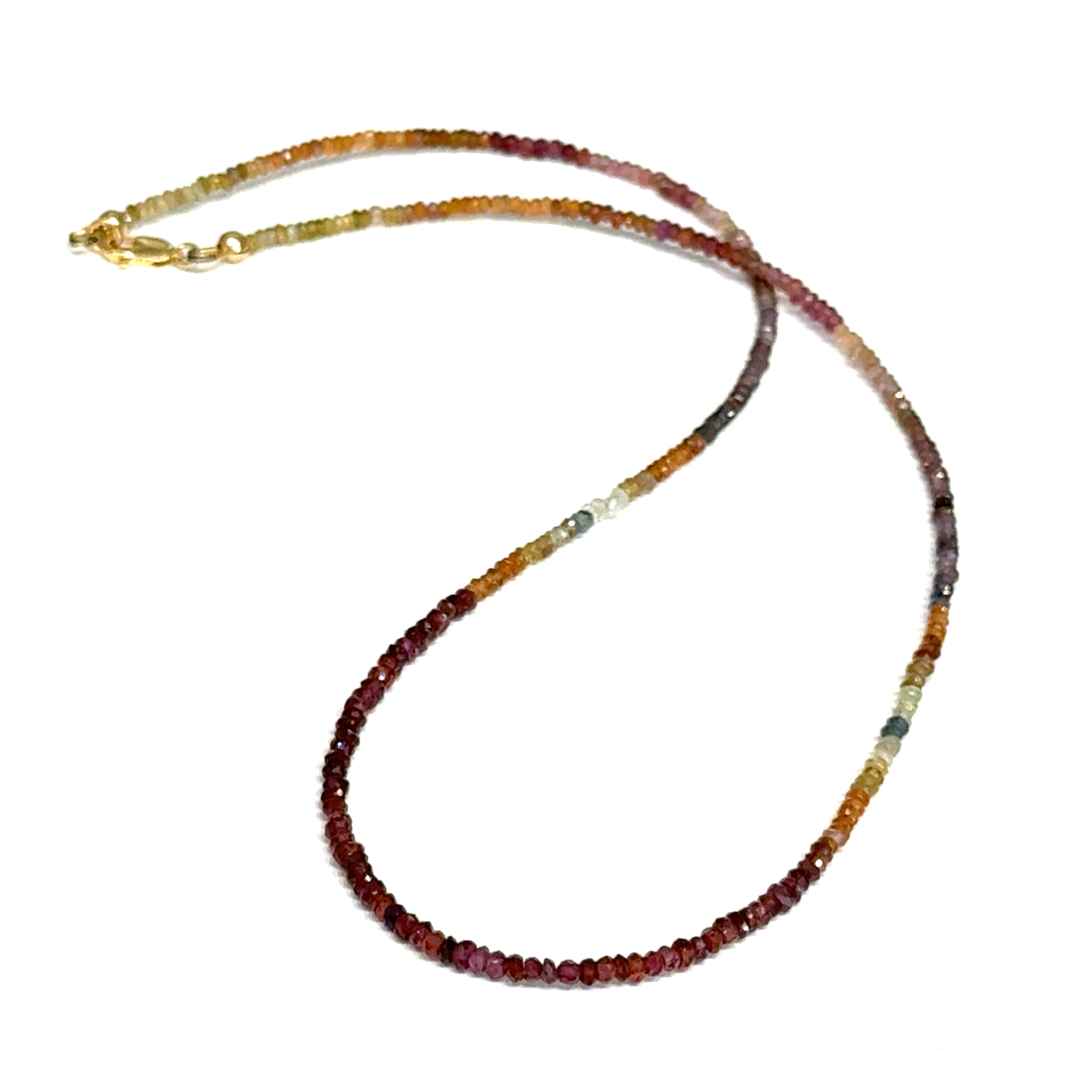Multicolored brown sapphire gemstone necklace with a gold-filled lobster-claw clasp on a white background, front overview.