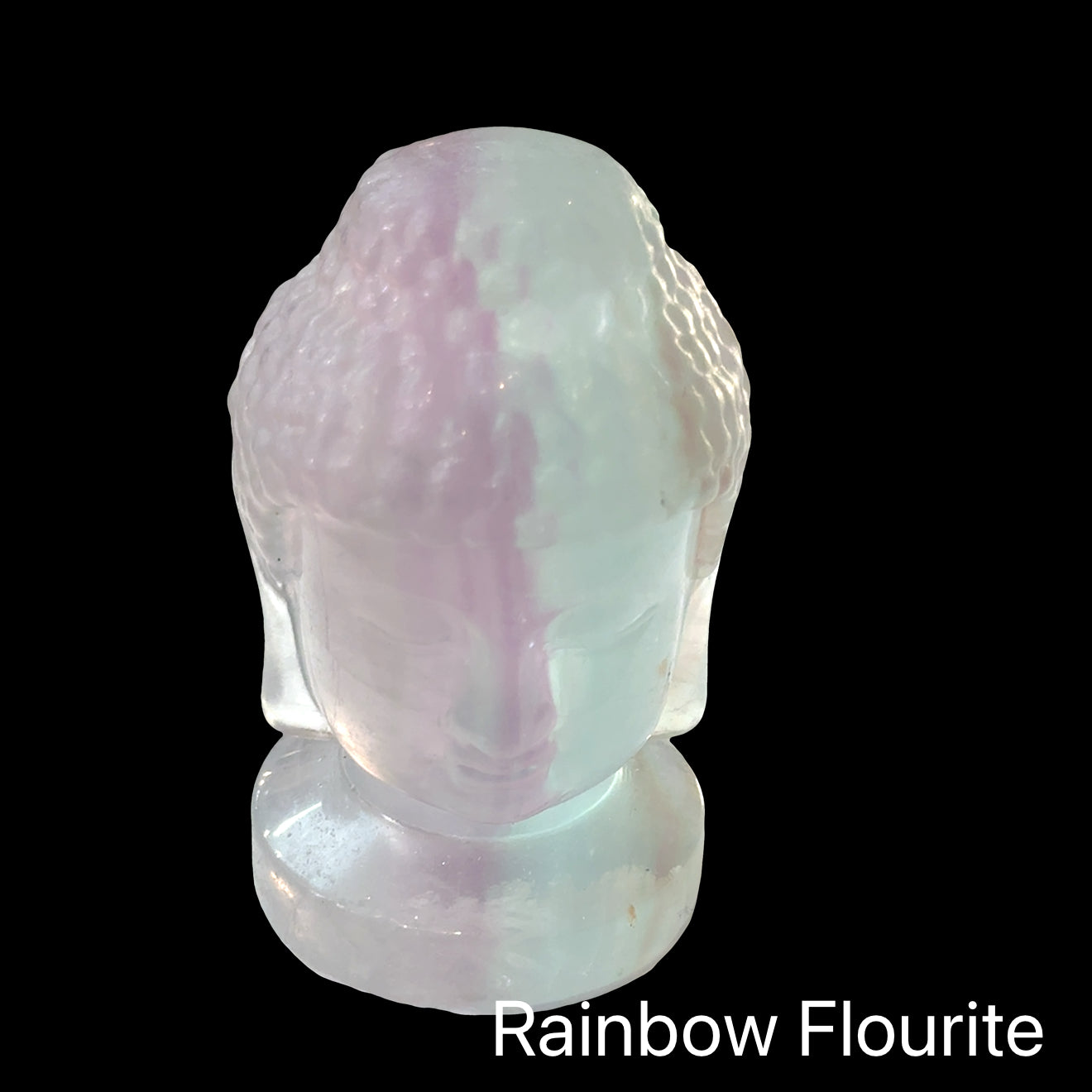 Natural rainbow fluorite Buddha head carving for organization routine building and spiritual awakening with peaceful enlightened consciousness, in a black background, front view. 