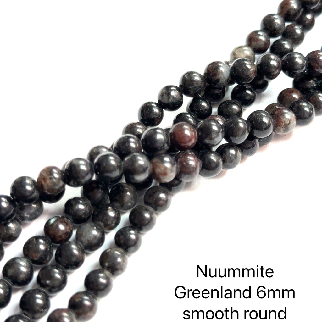 Nuummite Gemstone Strand 6mm smooth round on white close-up view