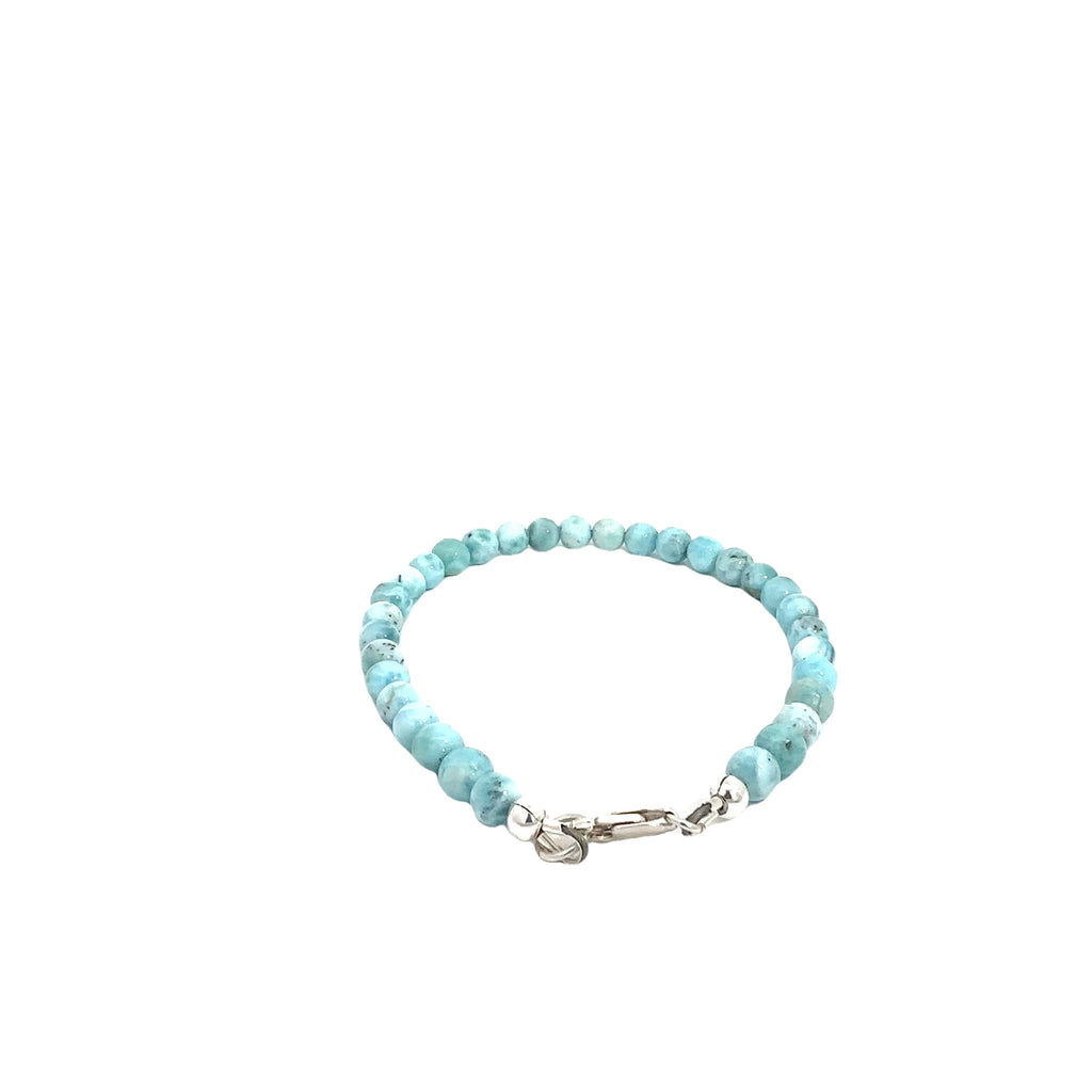 Ocean-blue Larimar beads strung on durable Beadalon wire with a sterling silver toggle on a white background, back center, close-up view. 
