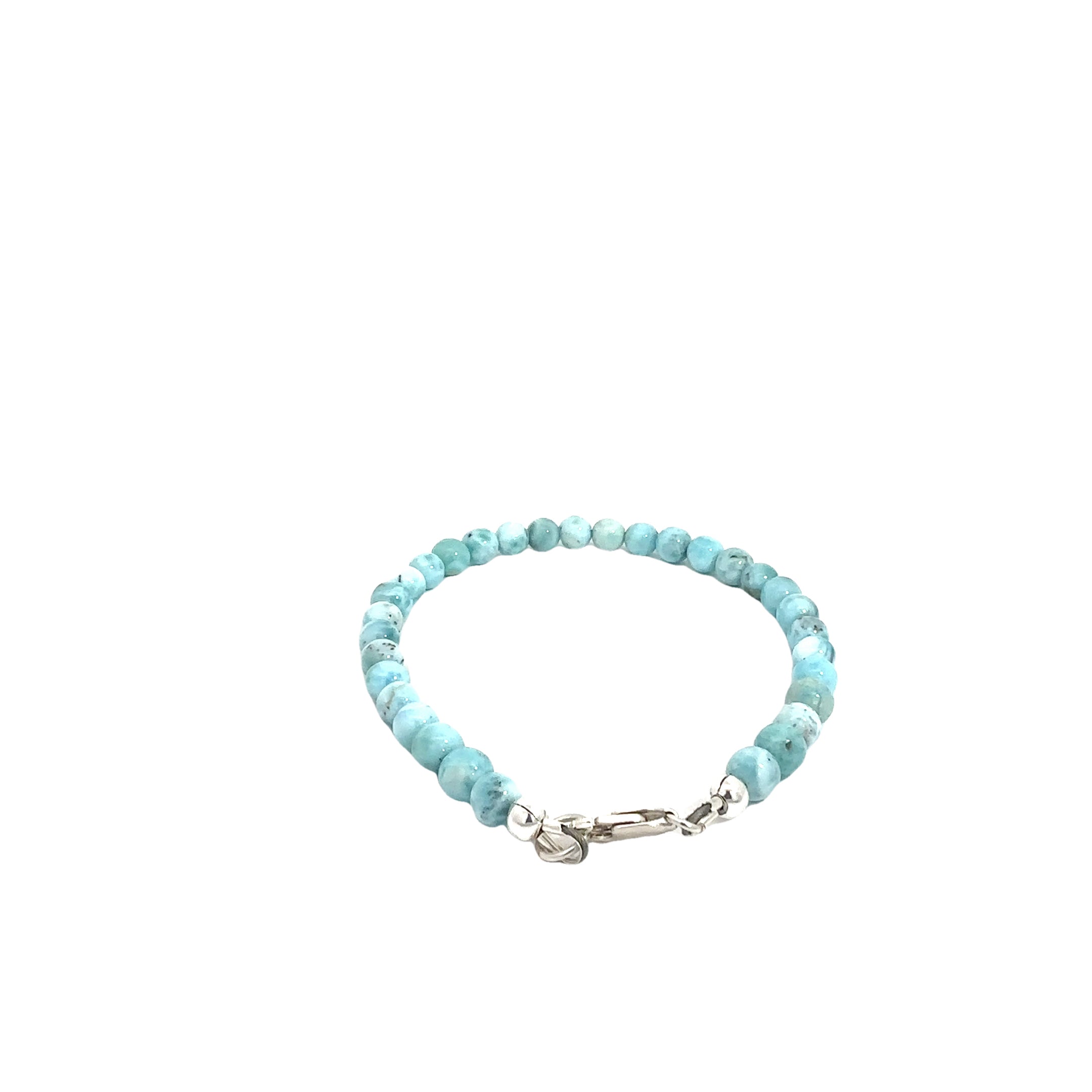 Ocean-blue Larimar beads strung on durable Beadalon wire with a sterling silver toggle on a white background, back center, close-up view. 