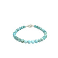 Ocean-blue Larimar beads strung on durable Beadalon wire with a sterling silver toggle on a white background, front center, close-up view. 
