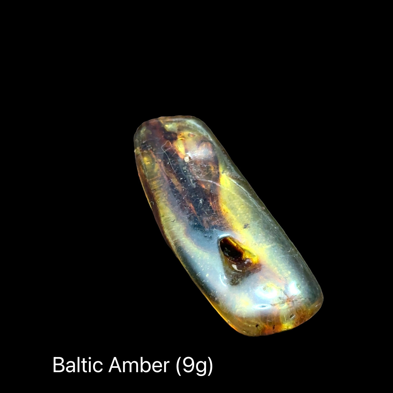One Baltic Amber on a black background with text indicating weight range (9g), front view.