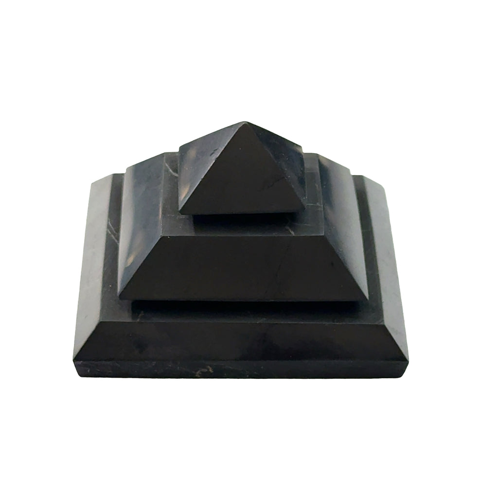 One Extra Large Black Shungite pyramid for EMF protection and electromagnetic shielding on a white background, front view.