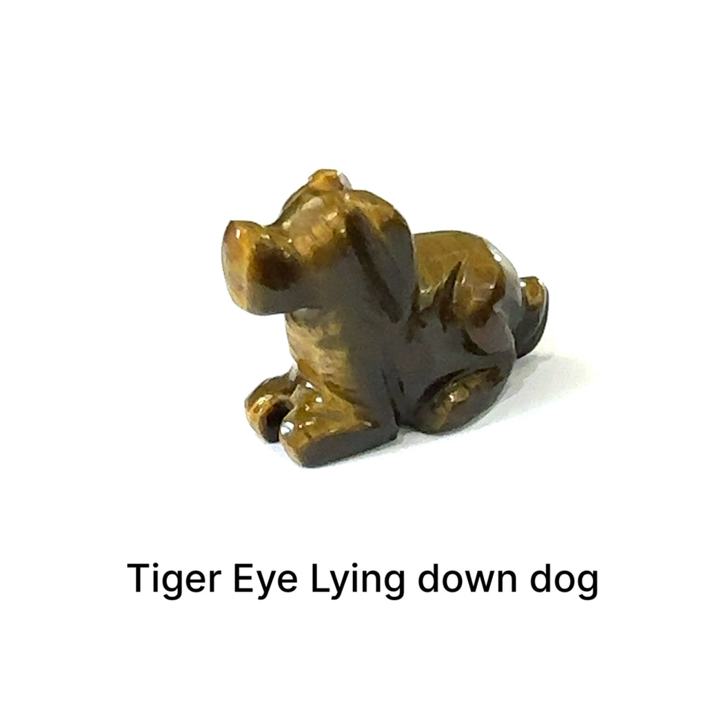 One Tiger Eye hound Dog gemstone carving lying down on white background, front view.