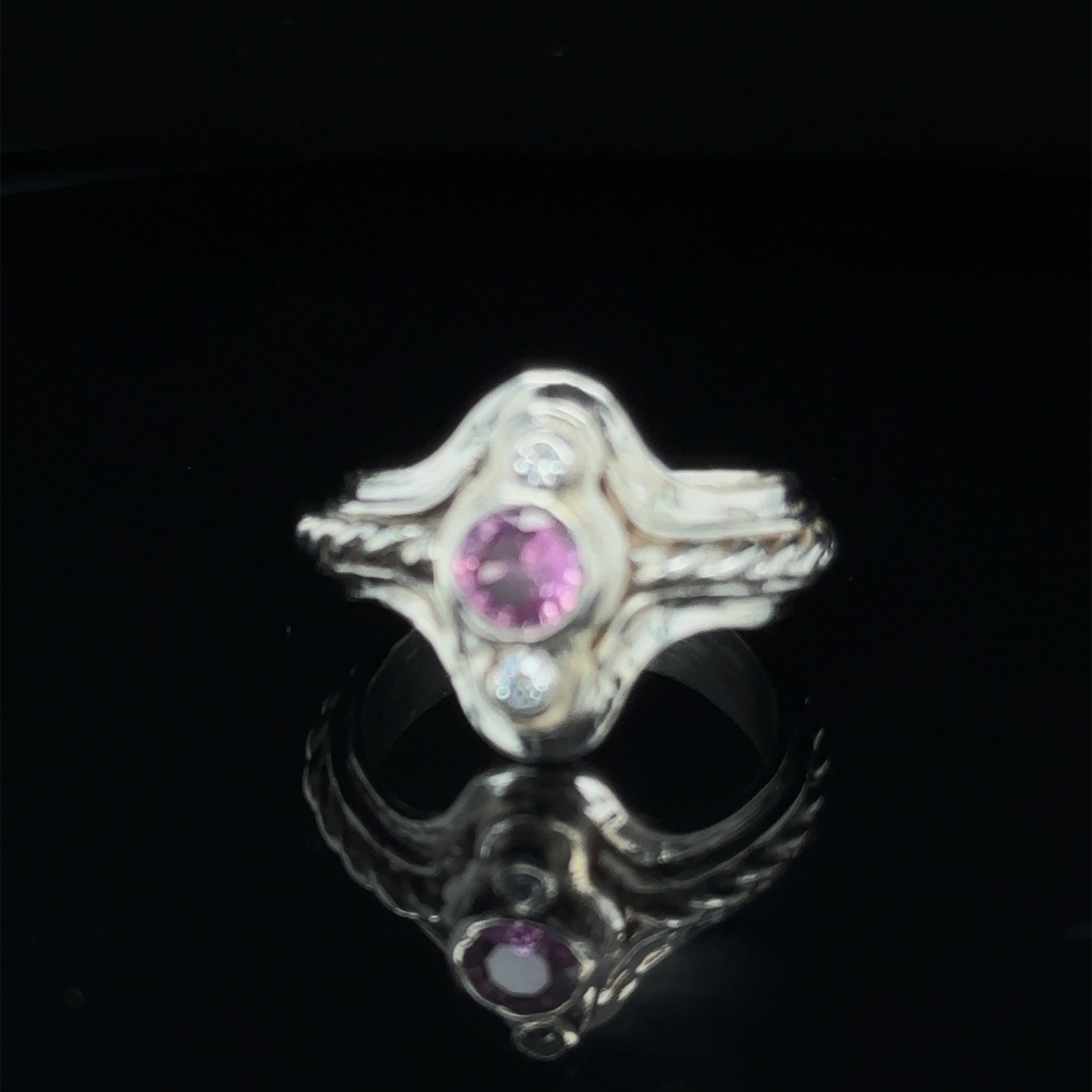 One‑of‑a‑kind artisan Pink Sapphire gemstone ring handcrafted in sterling silver on black slight angle view