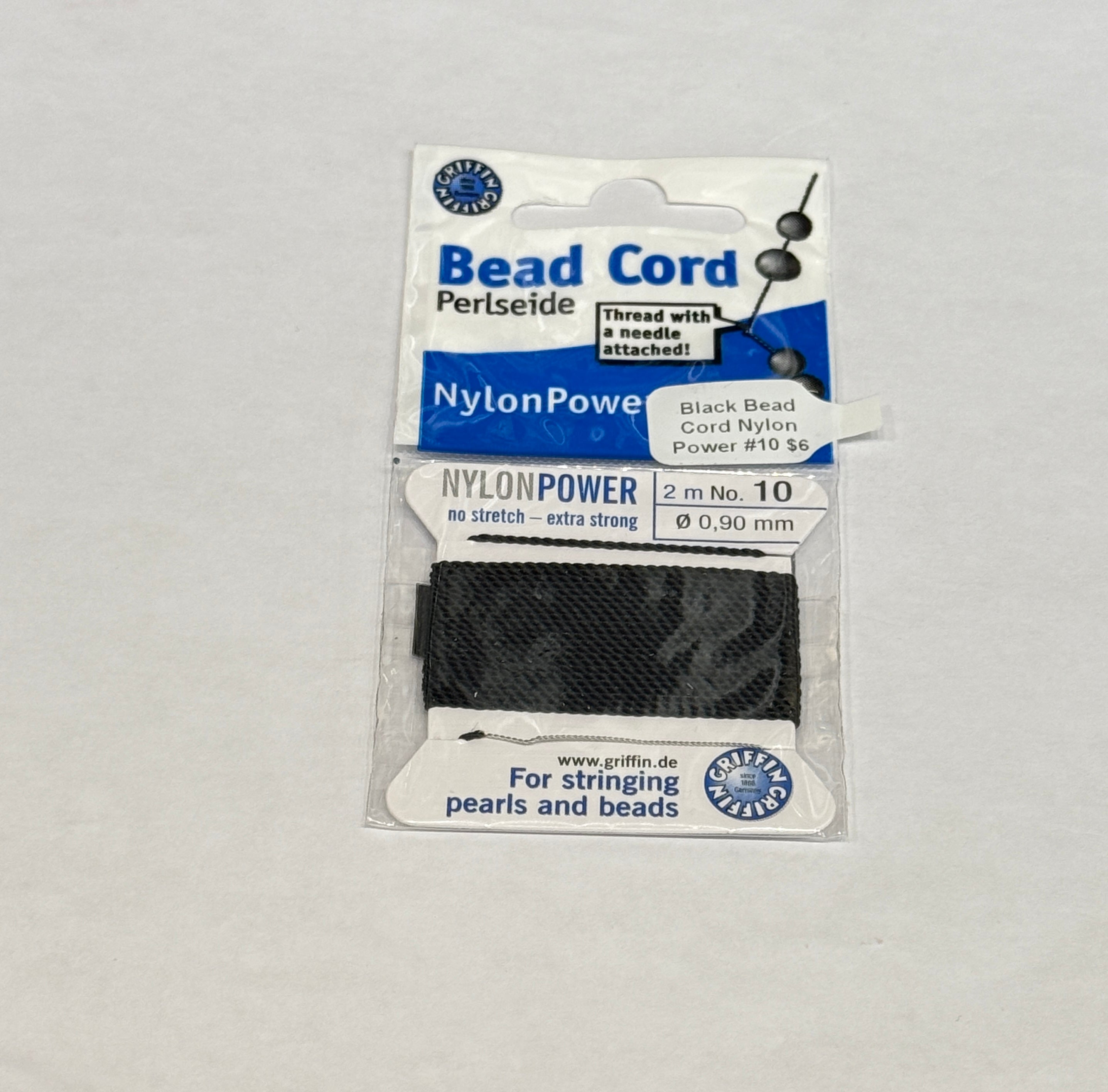 One package of Black Nylon Power Bead Cord  #10 on a white background, front view.