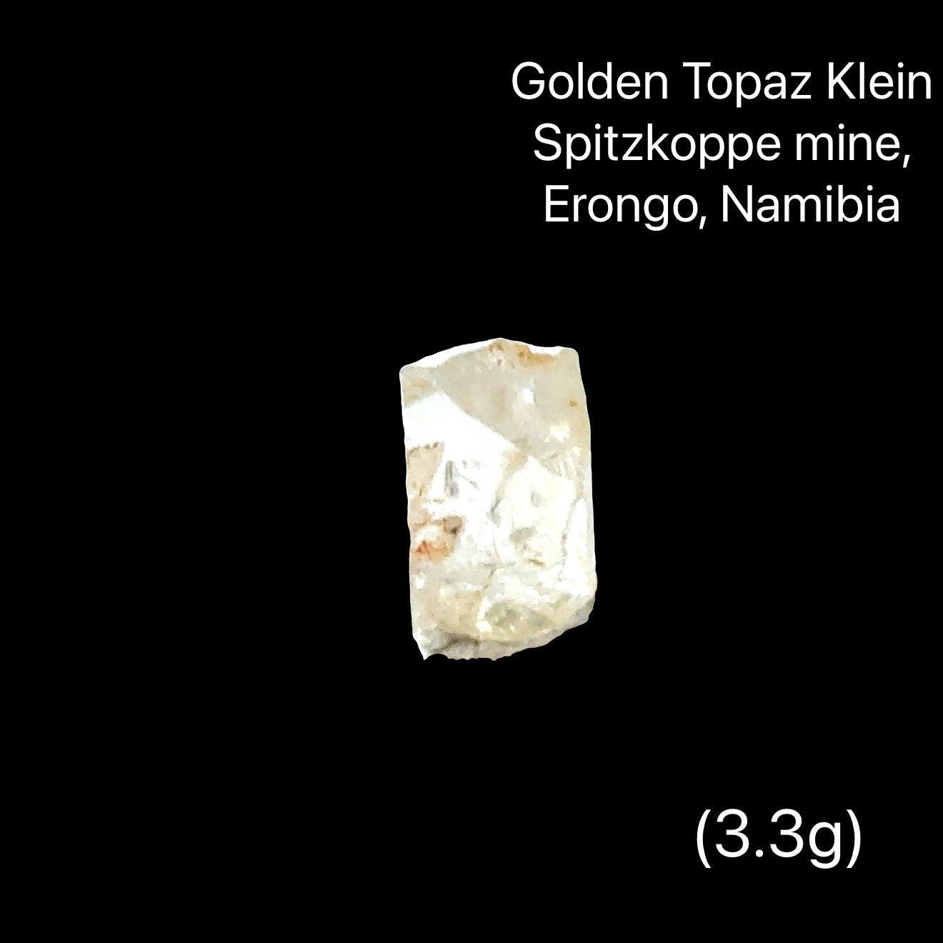 One rough golden topaz crystals on a black background with text indicating their origin (3.3g), front View.