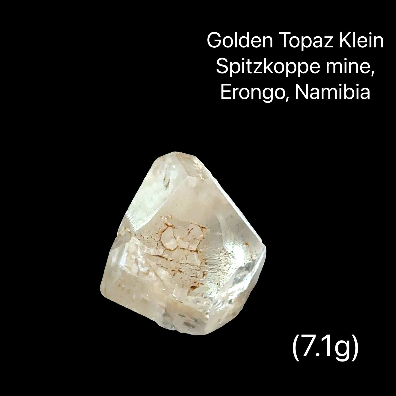 One rough golden topaz crystals on a black background with text indicating their origin (7.1), front View.
