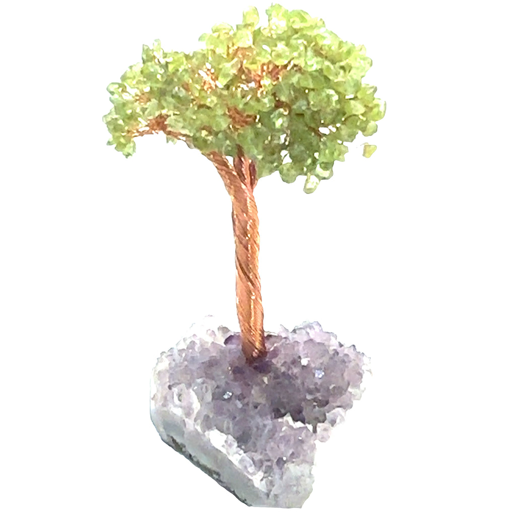 Peridot Gemstone tree placed on an altar for home décor and energy healing. On a white background, overview.