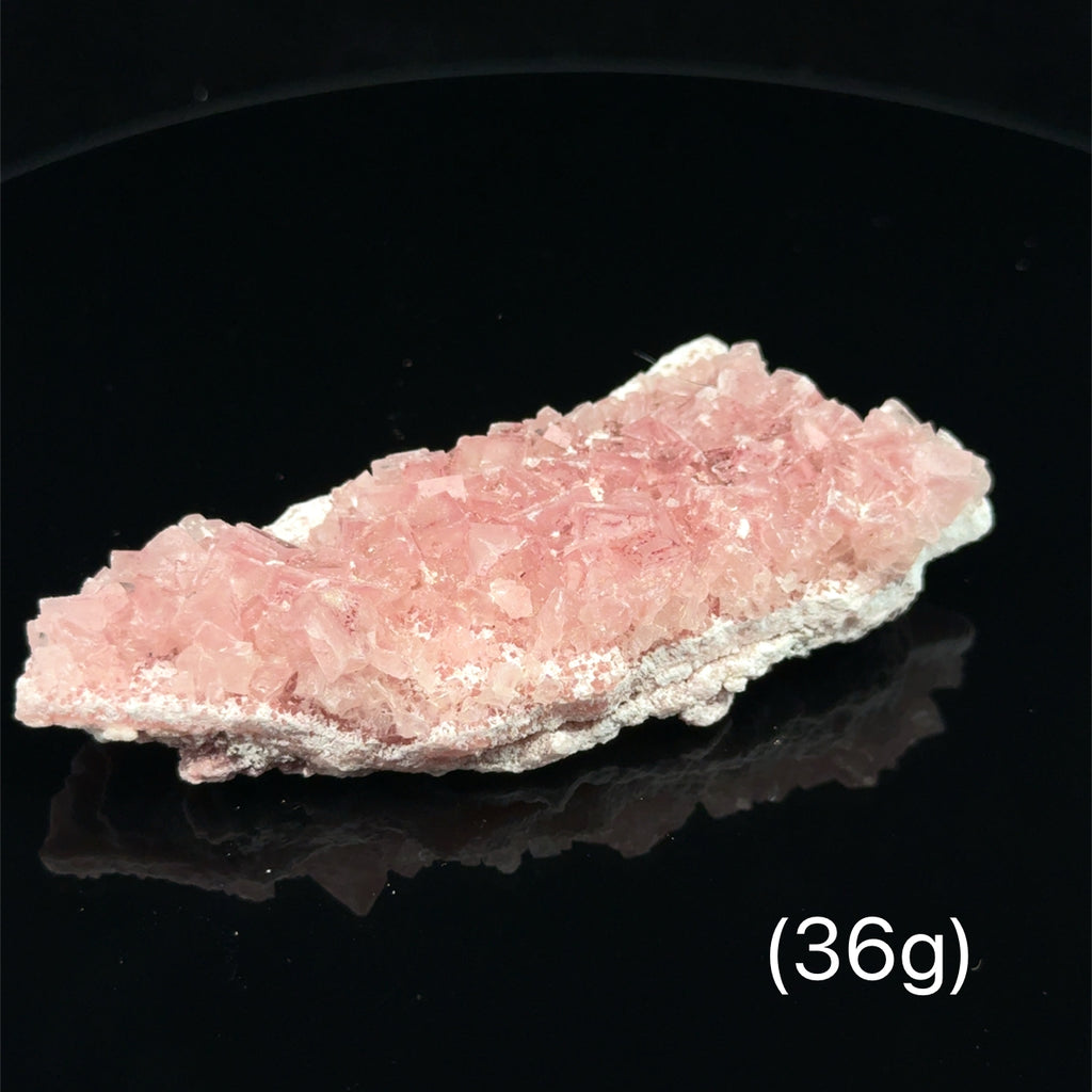 Pink Halite Raw Gemstone on black 36g front view