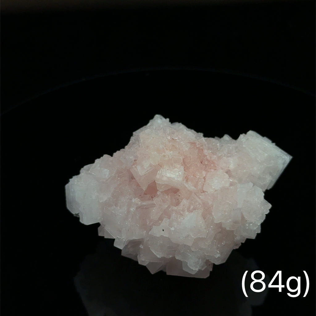 Pink Halite Raw Gemstone on black 84g front view