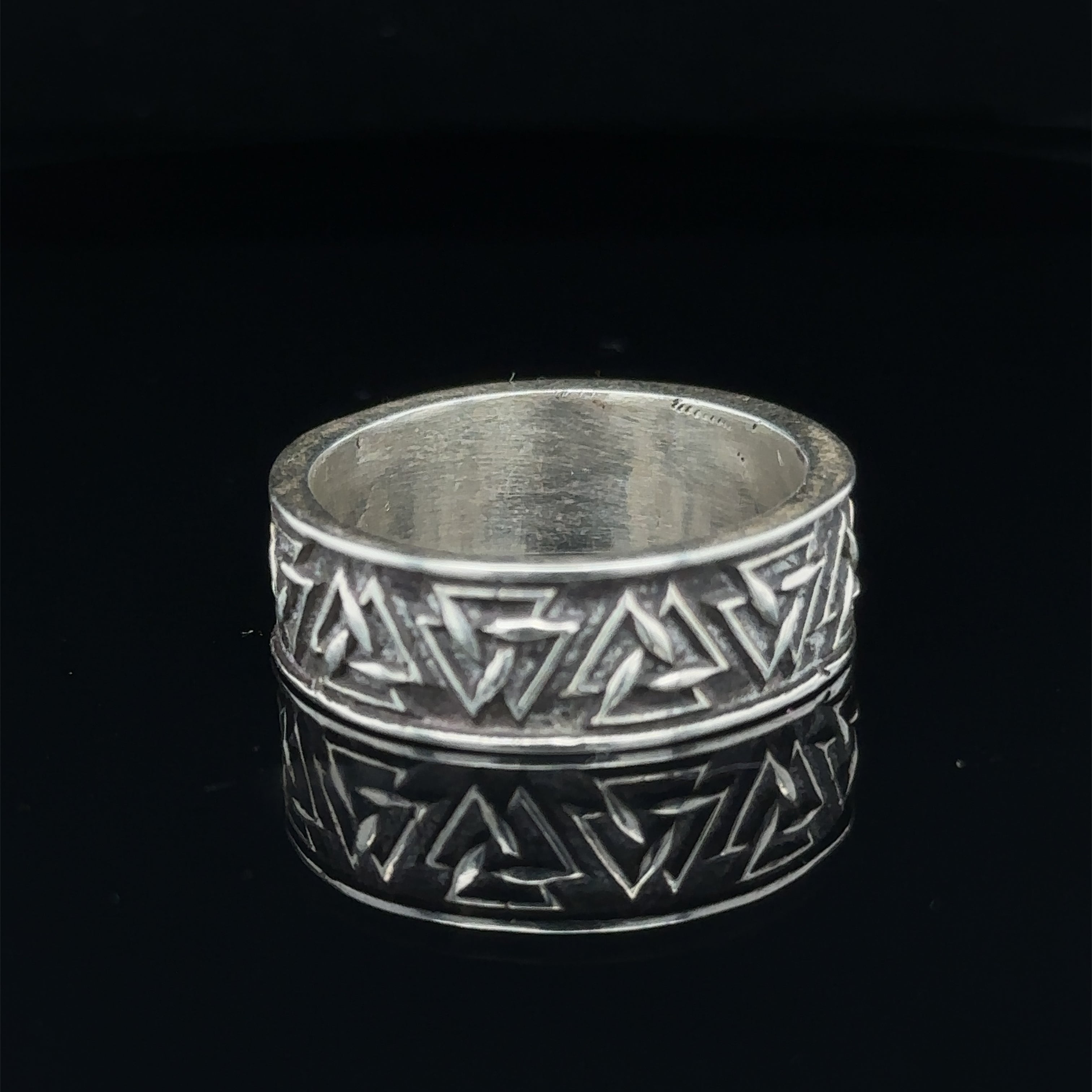 Polished sterling silver sacred shape ring for men’s fashion on black front view