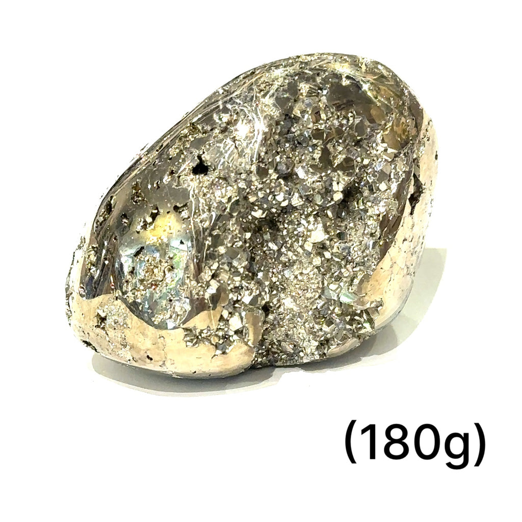 Pyrite free-form gemstone displayed in a spiritual altar setting, representing empowerment, grounding, and masculine energy. on white (180g) front up close view
