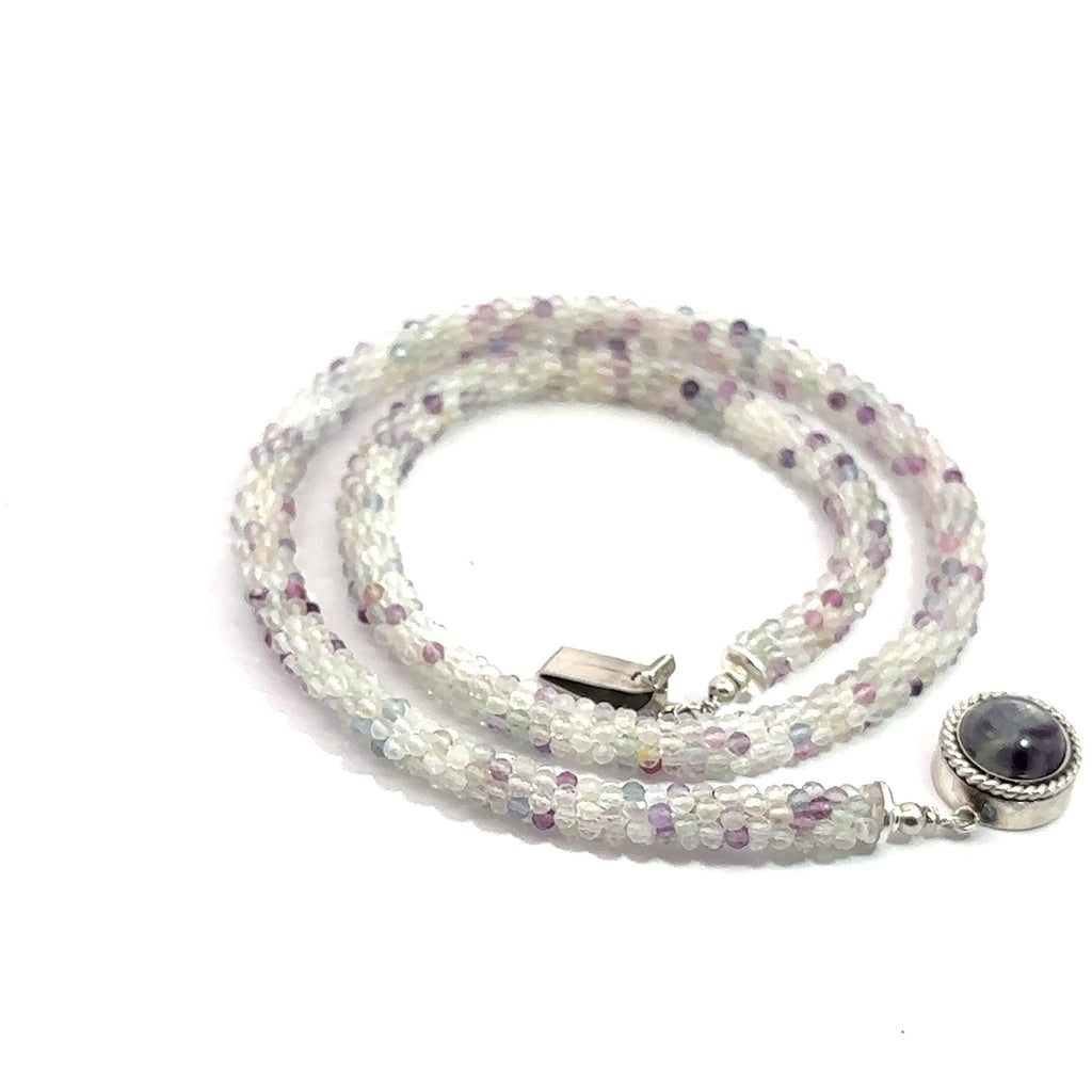 Rainbow Fluorite Gemstone Necklace on white spiral bottom angle overview