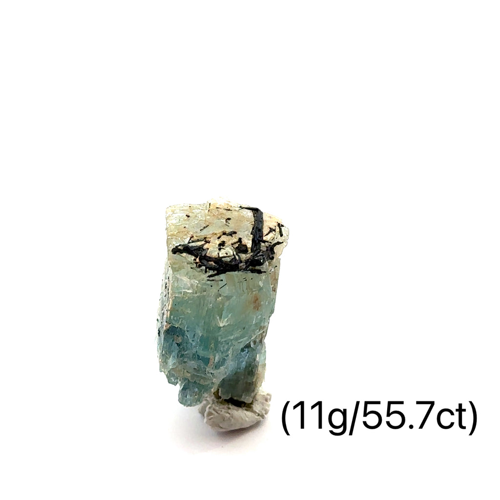 Raw Aquamarine with Schorl Gemstone 11g on white close-up