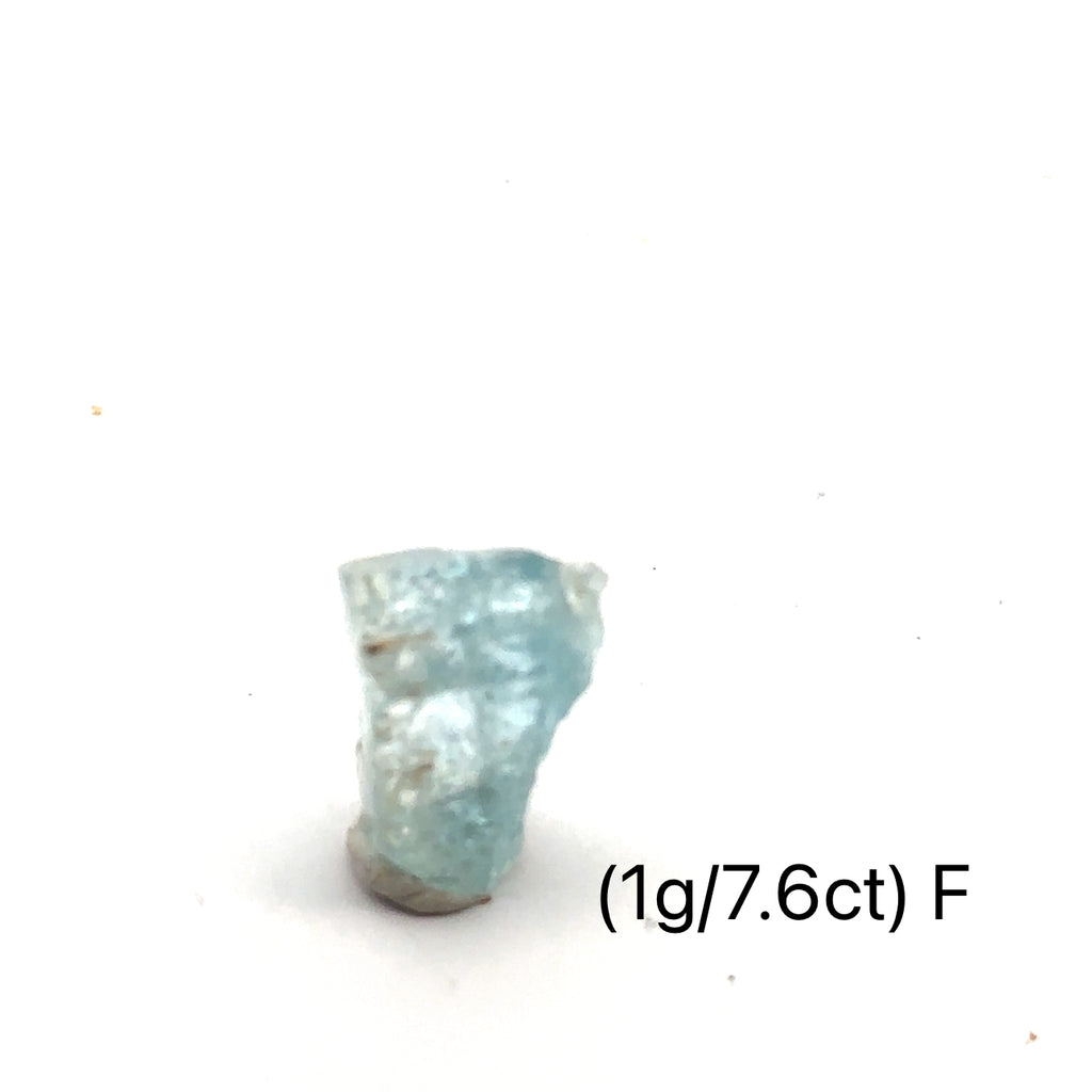 Raw Aquamarine with Schorl Gemstone 1g F on white close up overview