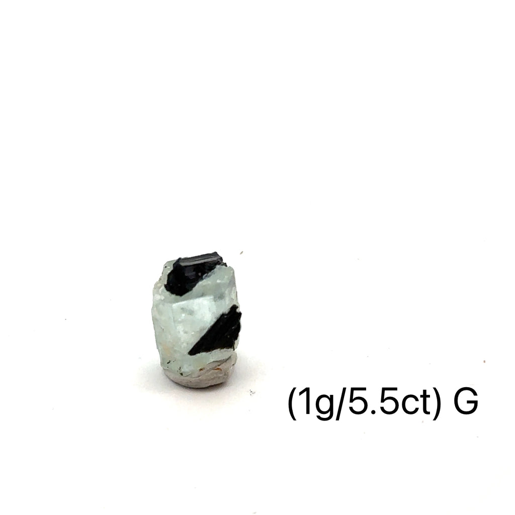 Raw Aquamarine with Schorl Gemstone 1g G on white close up overview