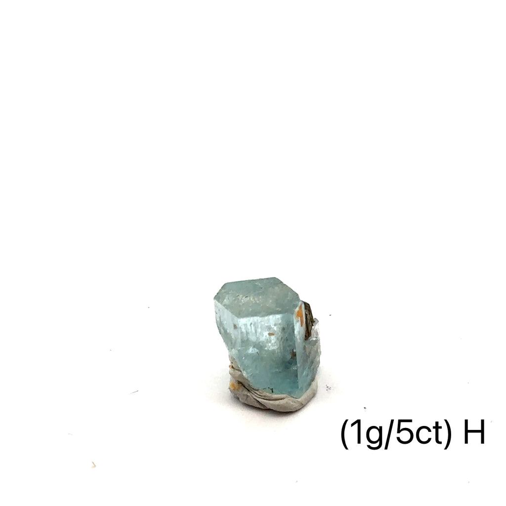 Raw Aquamarine with Schorl Gemstone 1g H on white close up overview