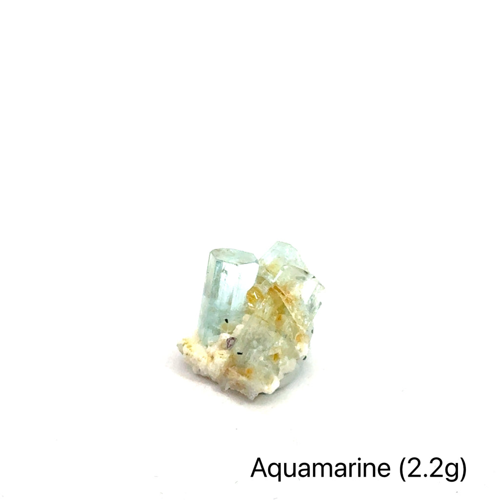 Raw Aquamarine with Schorl Gemstone 2.2g on white 