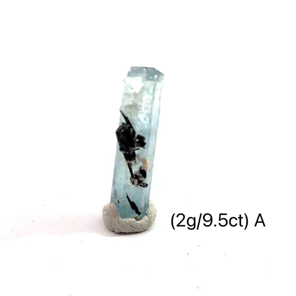 Raw Aquamarine with Schorl Gemstone 2g A on white close-up 