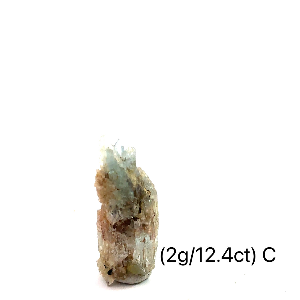 Raw Aquamarine with Schorl Gemstone 2g C on white close-up 