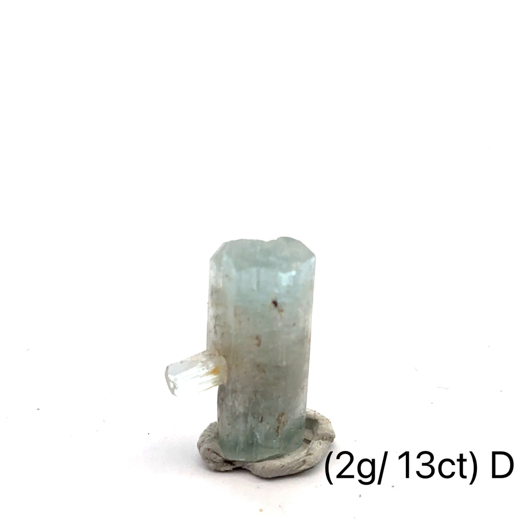 Raw Aquamarine with Schorl Gemstone 2g D on white close-up 