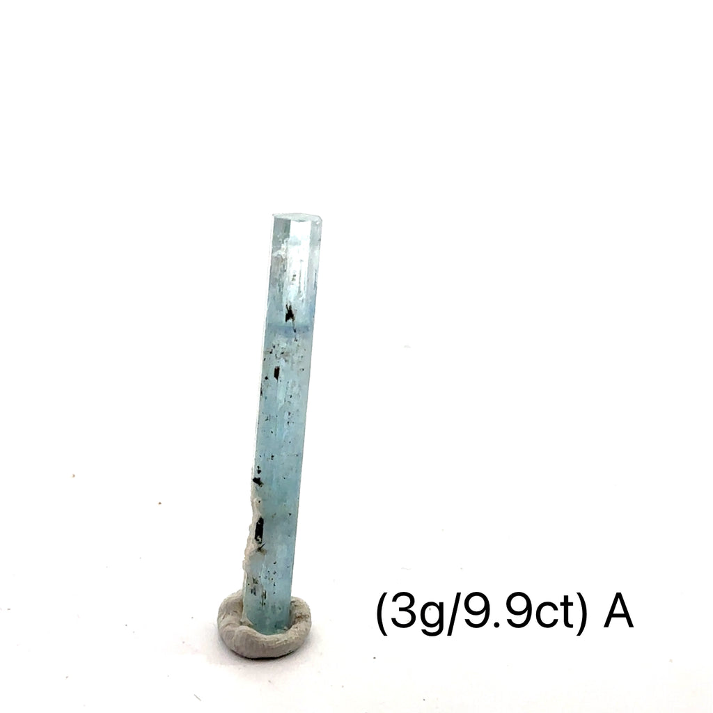 Raw Aquamarine with Schorl Gemstone 3g A on white close-up 