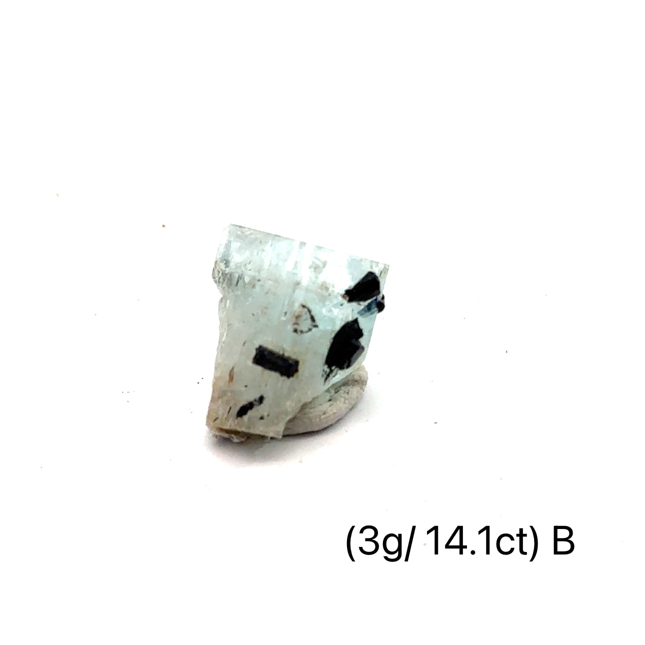 Raw Aquamarine with Schorl Gemstone 3g B on white close-up 