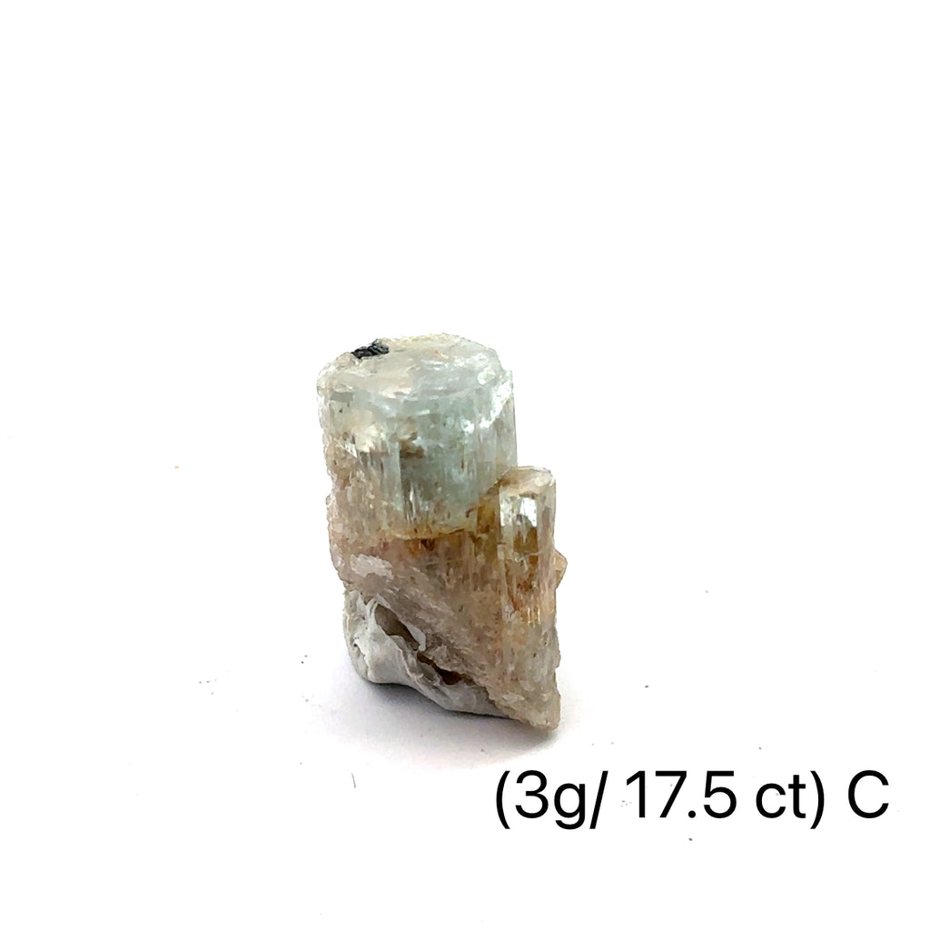Raw Aquamarine with Schorl Gemstone 3g C on white close-up 