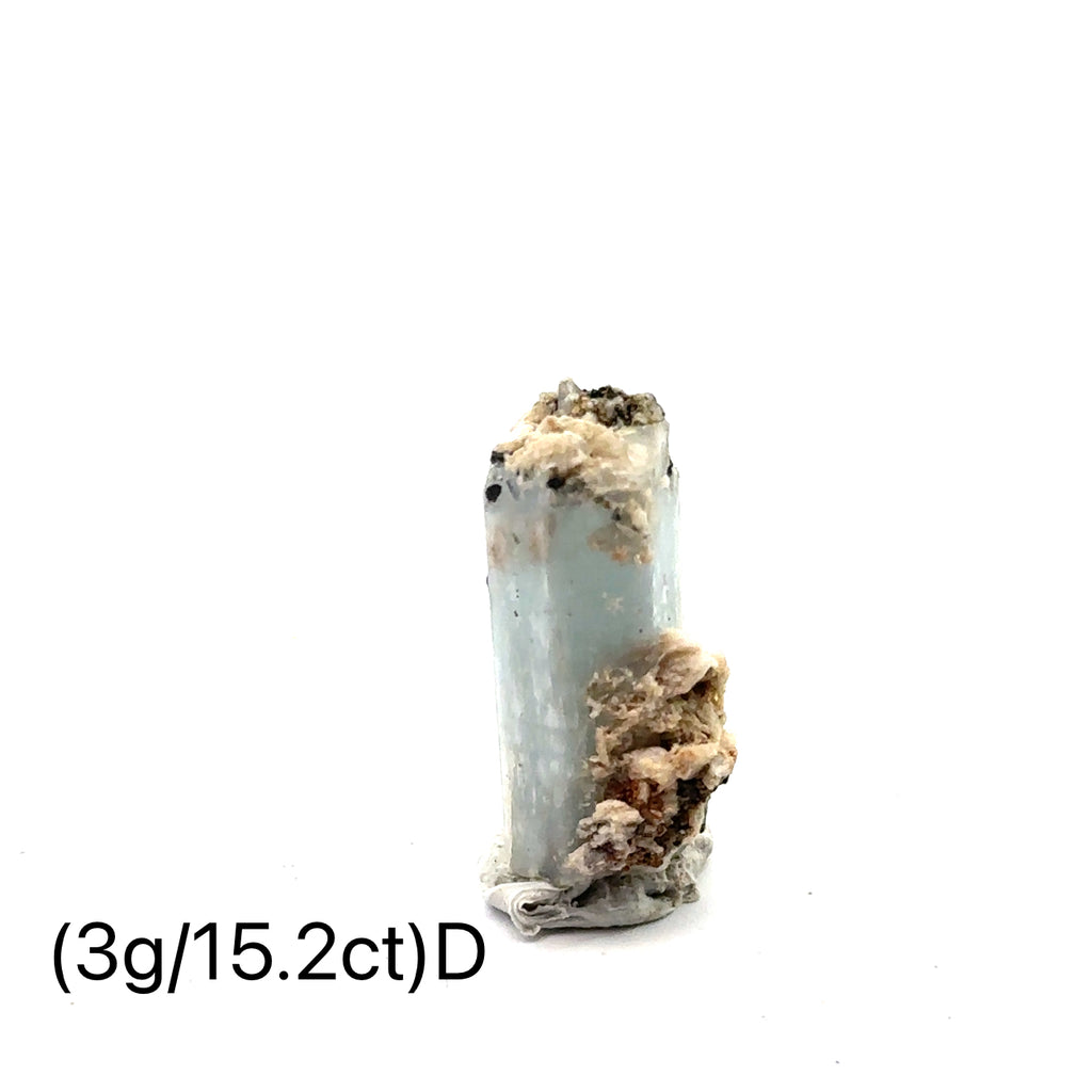 Raw Aquamarine with Schorl Gemstone 3g D on white close-up 