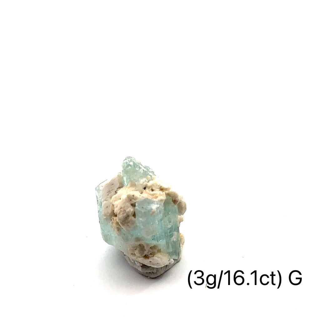 Raw Aquamarine with Schorl Gemstone 3g G on white close-up 
