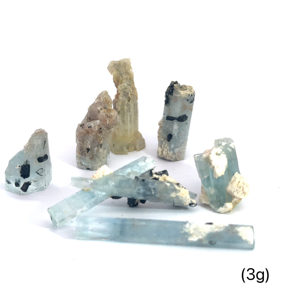 Raw Aquamarine with Schorl Gemstone 3g on white overview 