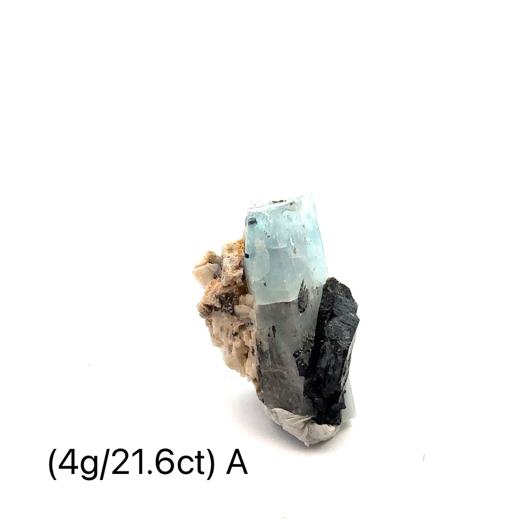 Raw Aquamarine with Schorl Gemstone 4g A on white close-up 