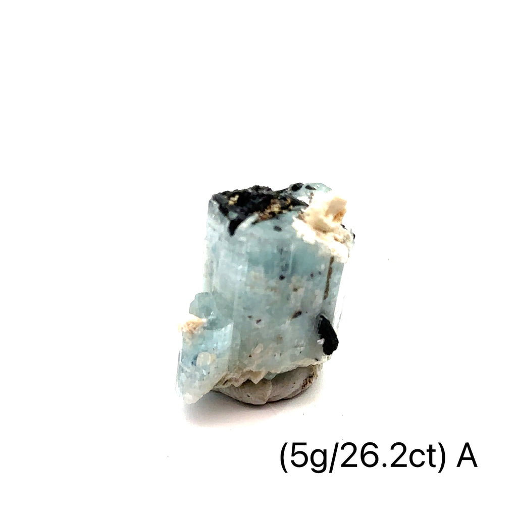 Raw Aquamarine with Schorl Gemstone 5g A on white close-up 