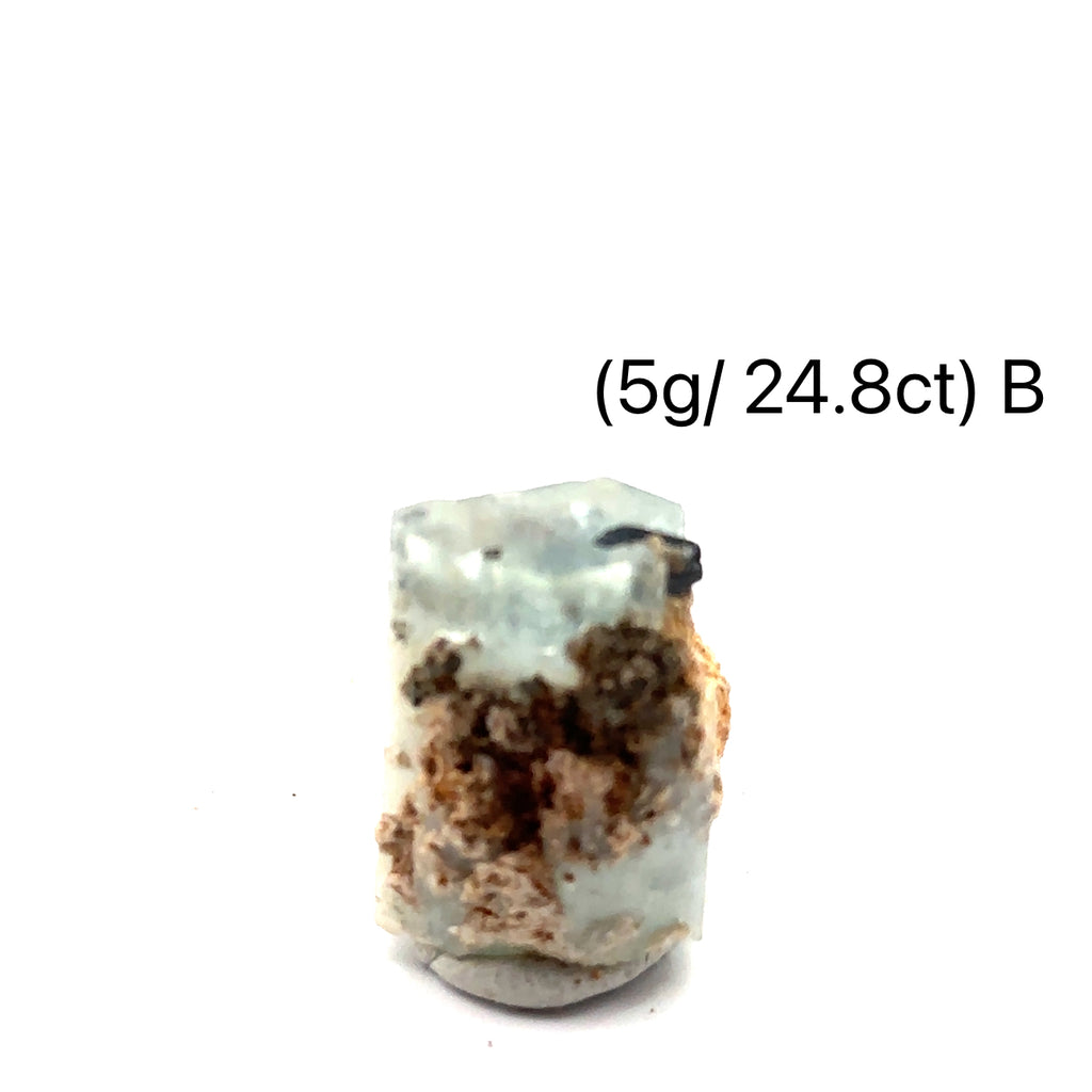 Raw Aquamarine with Schorl Gemstone 5g B on white close-up 