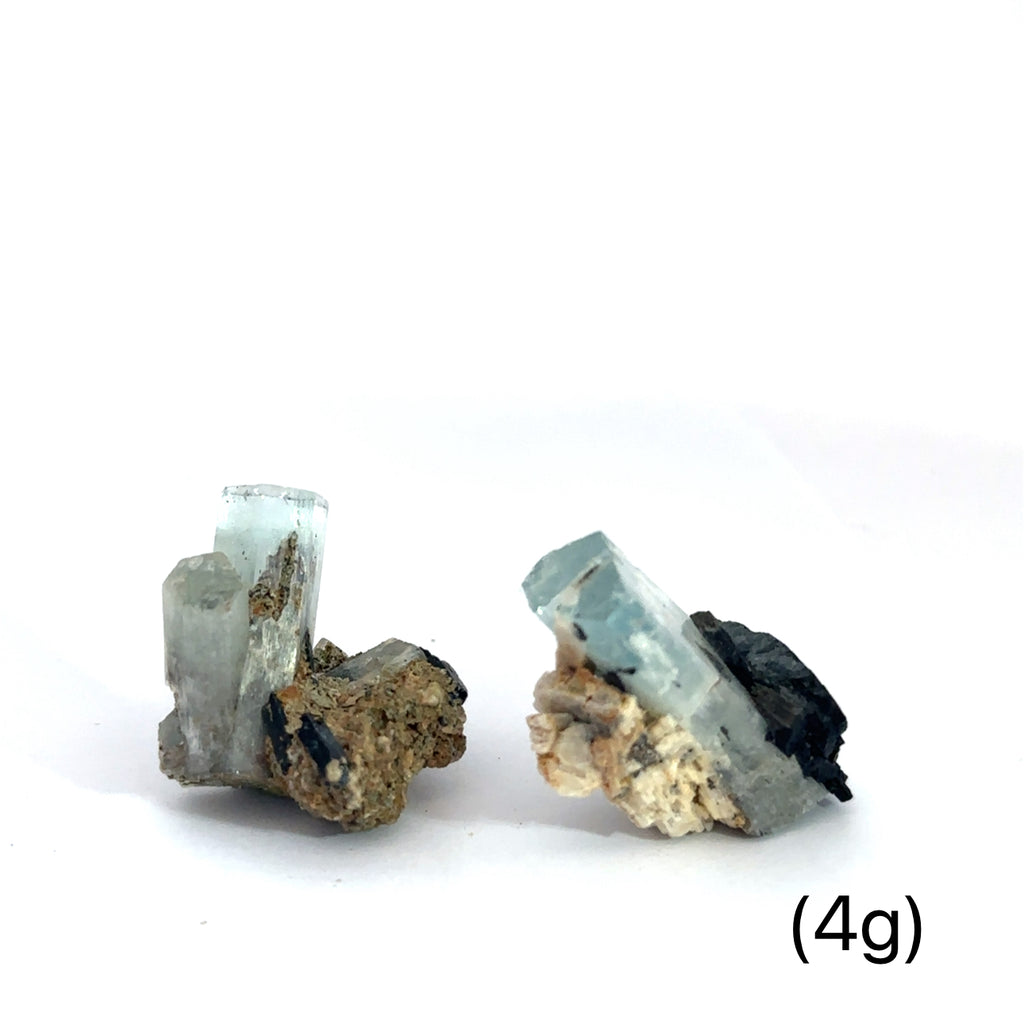 Raw Aquamarine with Schorl Gemstonen4g on white overview 