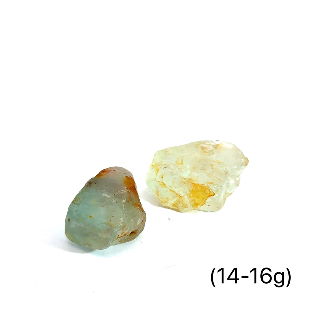 Raw Blue Topaz Gemstone on white grouping 14-16g close up front view 