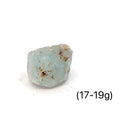 Raw Blue Topaz Gemstone on white grouping 17-19g front view 