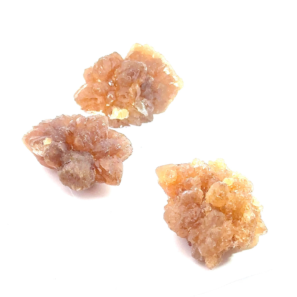Raw Citrine Spray Gemstone from Morocco grouping on white close up overview