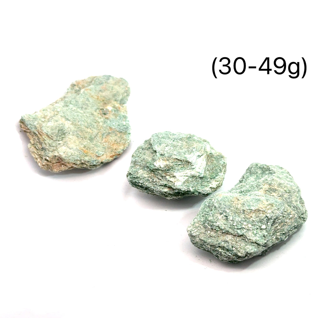 Raw Fuchsite Gemstone grouping on white 30-49g overview 