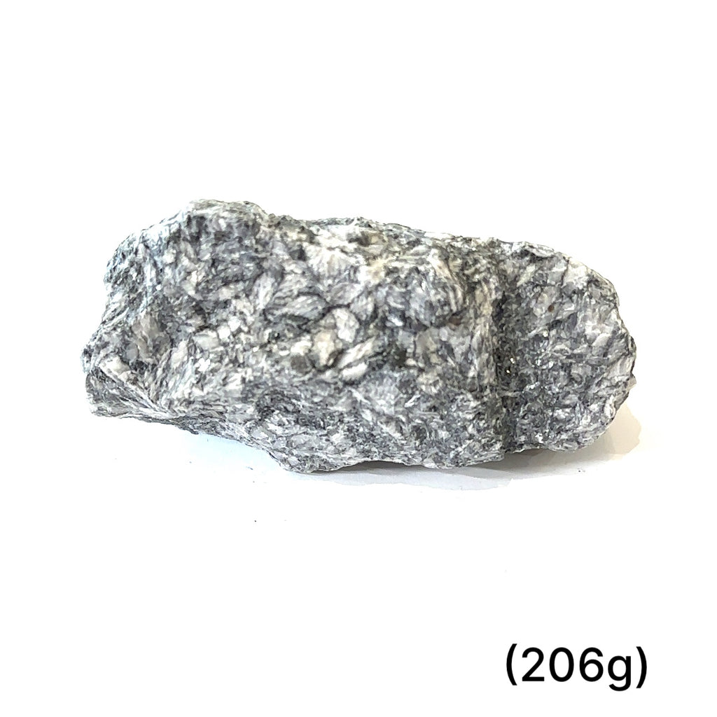 Raw Pinolith gemstone for Crown, Heart, and Root chakra alignment (206g) on white front view